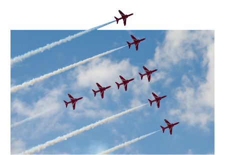 Red aircraft flying in formation against a blue sky