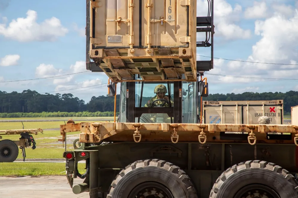 Forklift lifting a freight container during Army container-handling operations